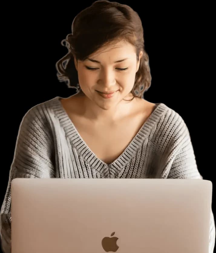 A woman sitting in front of a laptop