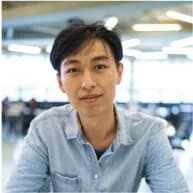 A man sitting at a table with a plate of food in front of him.