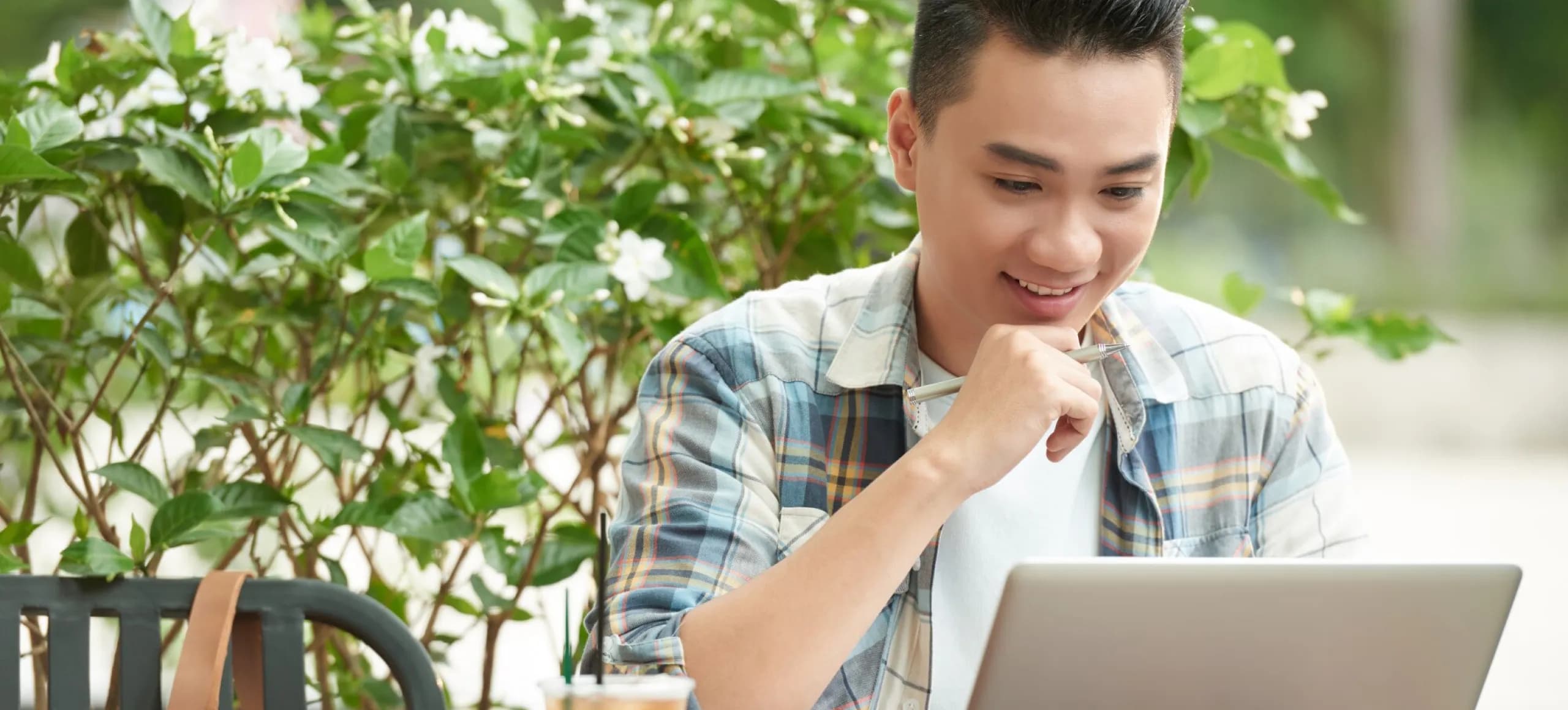 A man sitting in front of a laptop computer.
