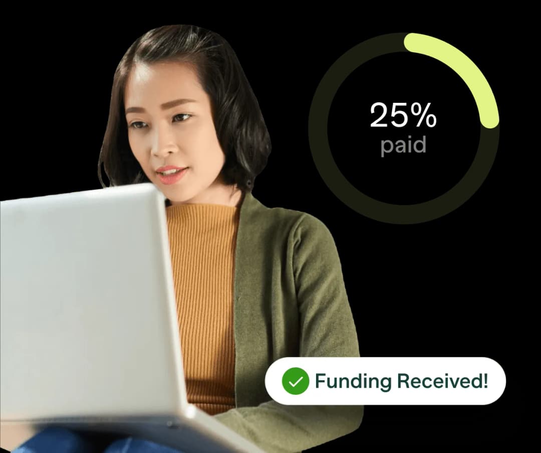 A woman sitting in front of a laptop computer.