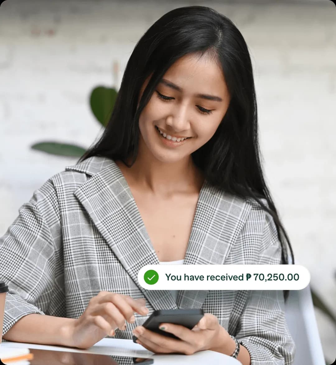 A woman receiving funds on her phone