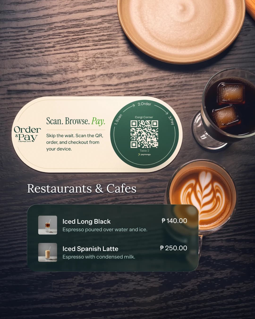 An Order and Pay QR card on a café table beside an iced long black and a latte, with the café's digital menu — Iced Long Black, Iced Spanish Latte — shown over it