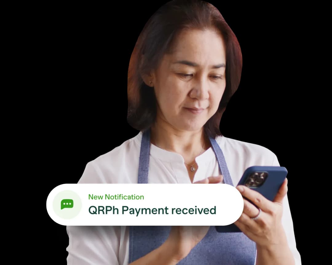 A woman holding a cell phone in her hands