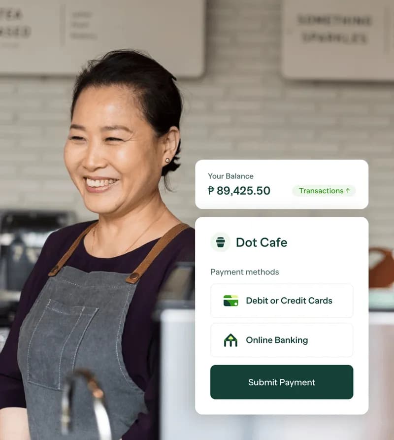 A woman in an apron is smiling at the camera