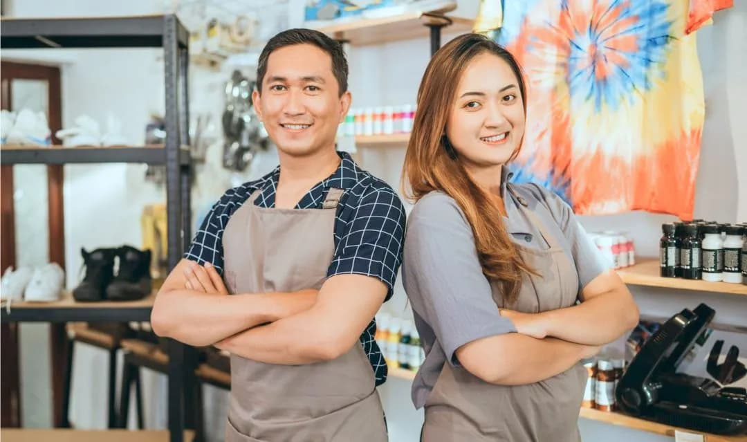 A couple of people that are standing in a room.