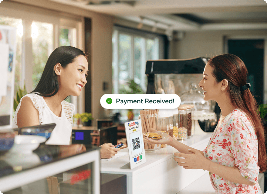 A customer pays via QR Ph at a café counter with Payment Received confirmation displayed